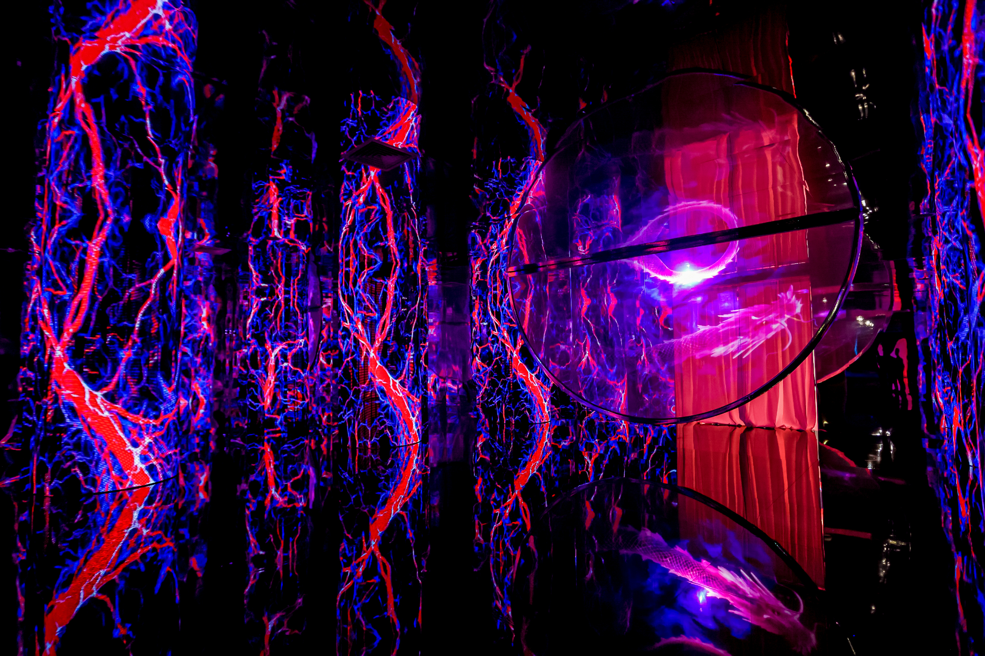 Neon red and blue chamber with mirrored orb and dragon AR illusion
